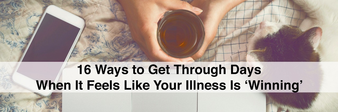 16 Things to Do When It Feels Like Your Illness Is 'Winning' Top view image of woman hands on her bed using a laptop while drinking tea and petting a cat. with text 16 ways to get through days when it feels like your illness is winning