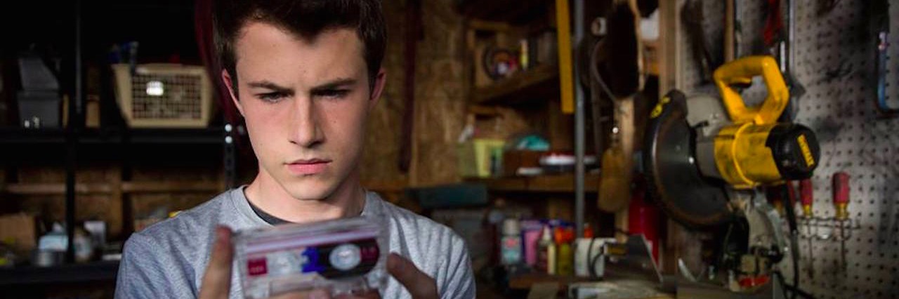 What Parents Should Know About '13 Reasons Why' A teenage boy holding a tape