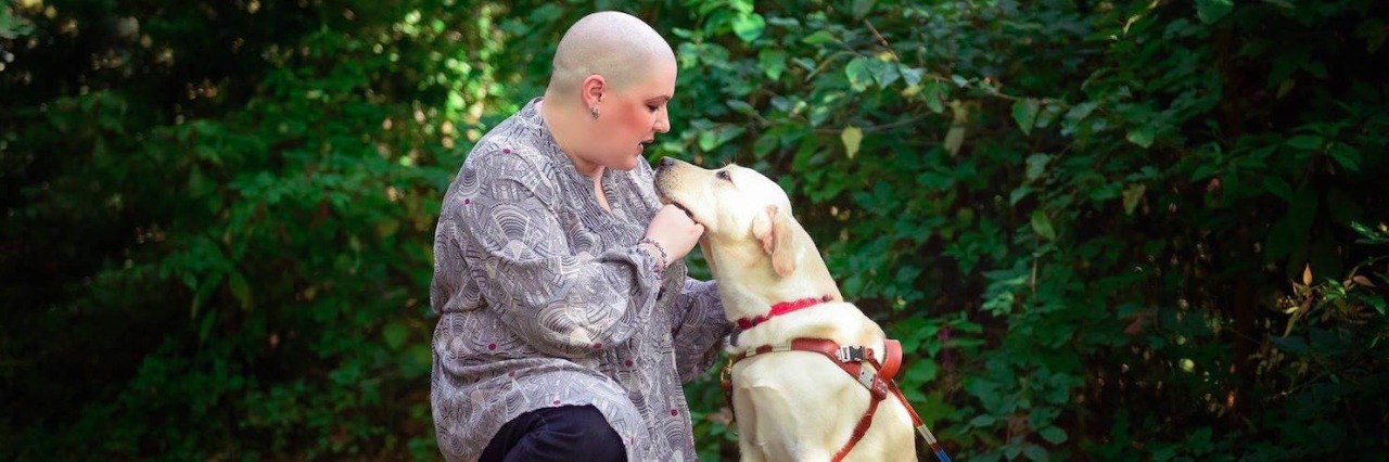 Responding to Comment About Body After Telling Them I'm Blind Holly and her guide dog in a park, with Holly kneeling next to her guide dog, both of them looking at each other