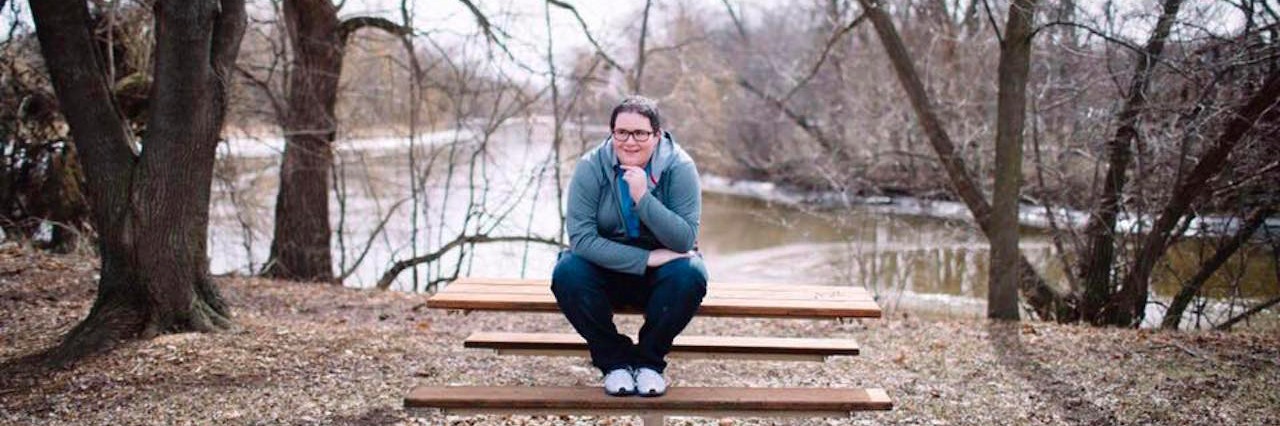Reaction to Amy Bleuel's Death From Someone With a Semicolon Tattoo Amy Bleuel sitting in a bench
