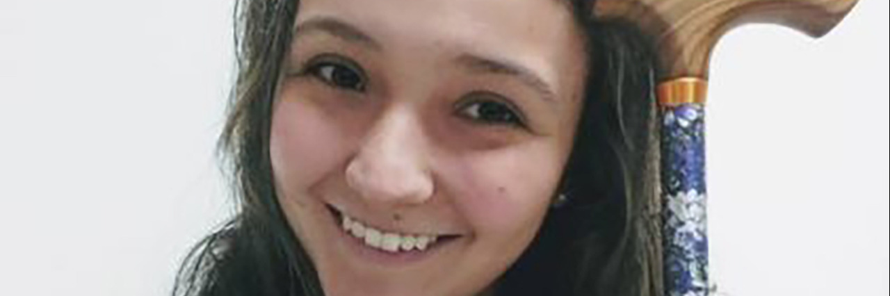 Reactions to My Cane as a Young Woman With Fibromyalgia Mariana with her cane.