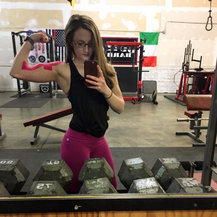 woman making fist at gym