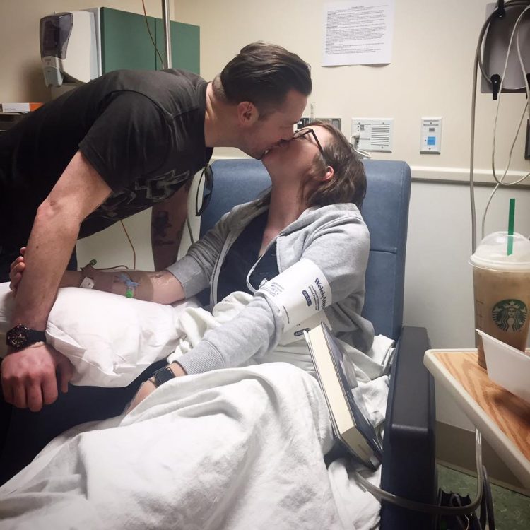woman in hospital kissing husband