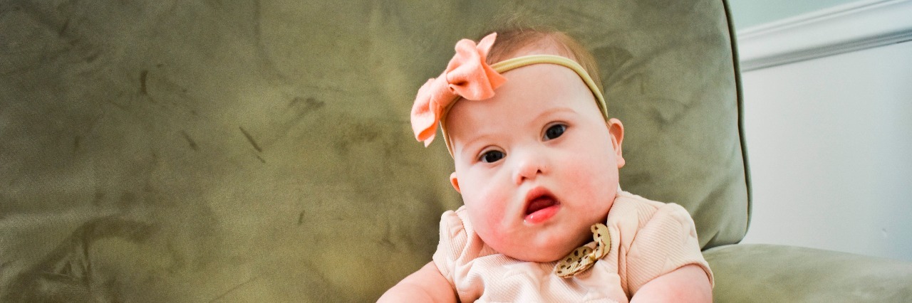 When a Cashier's Question After My Daughter's Surgery Made Me Cry baby sitting on couch