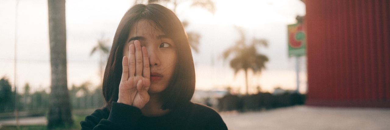 Why We Need to Talk About Health Anxiety in Lyme Disease girl wearing sweatshirt that says don't worry with one hand over her face