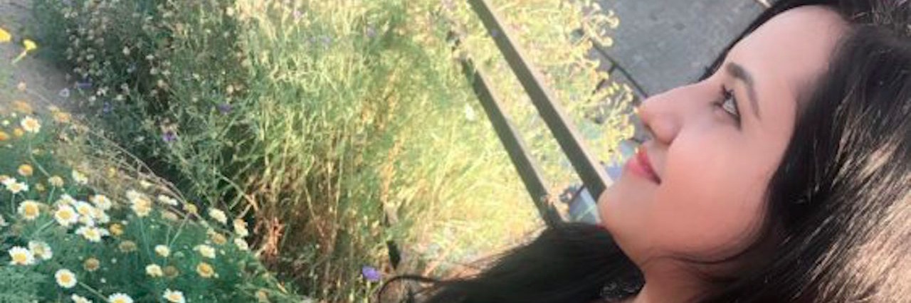 Why Chronic Fatigue Syndrome Is More Than 'Just Tiredness' woman standing in garden