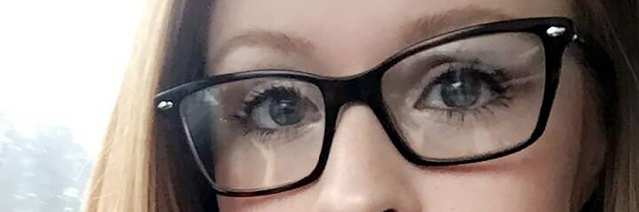 The Panic Attack That Was Different to All My Others young woman wearing glasses and green scarf