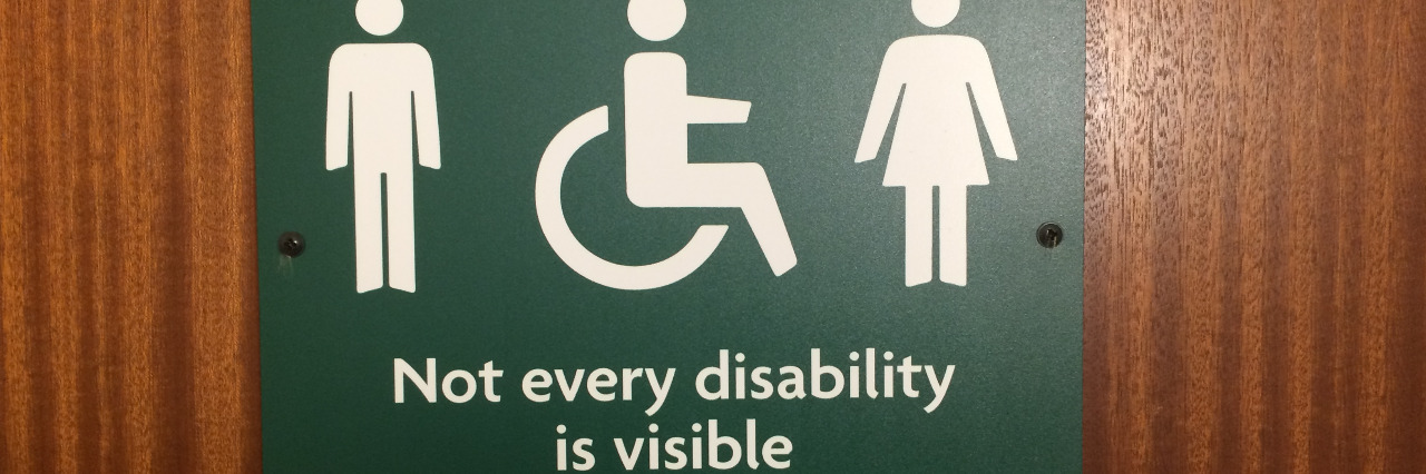 Bathroom sign saying "not every disability is visible.'