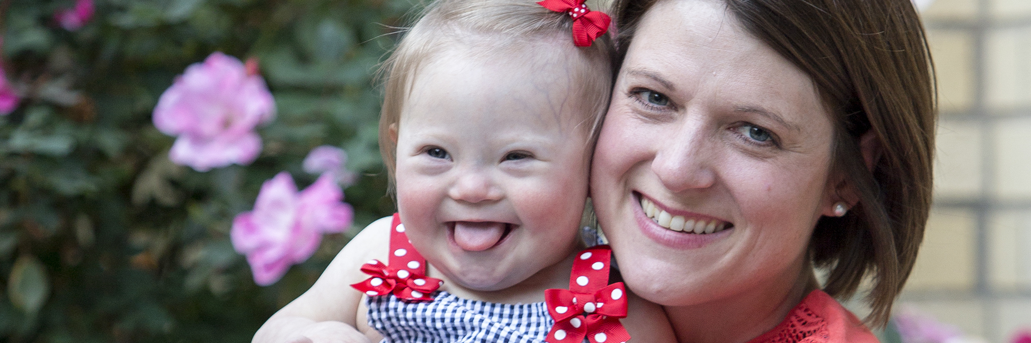 Down Syndrome and the Value of Human Life Alisa and her mom sitting on a bench outdoors.
