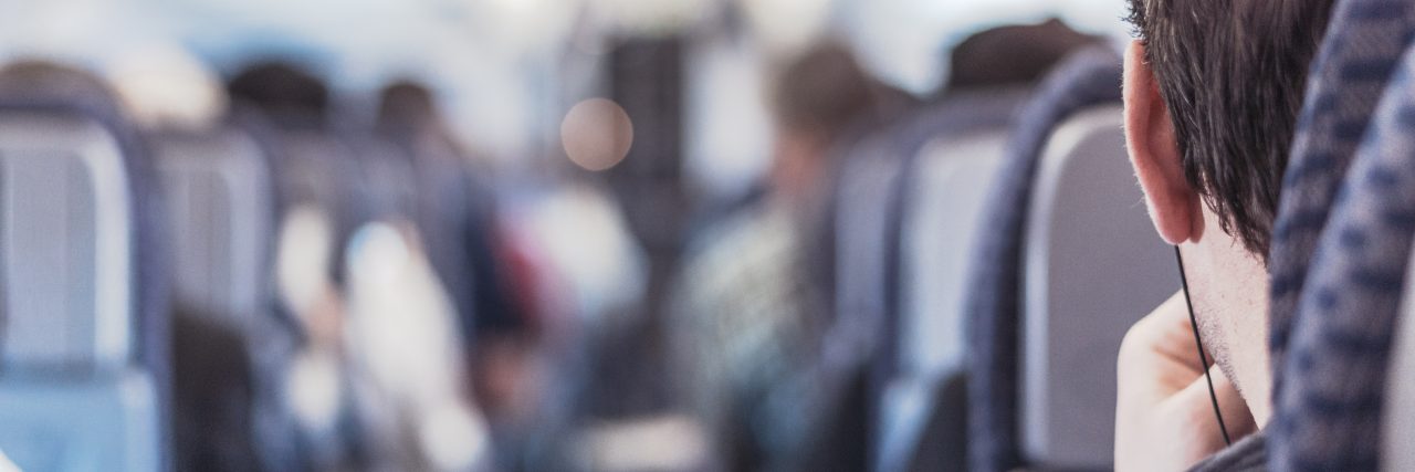 Man With Disability Says He Was Removed From American Airlines Flight Photo of a man sitting on a plane.