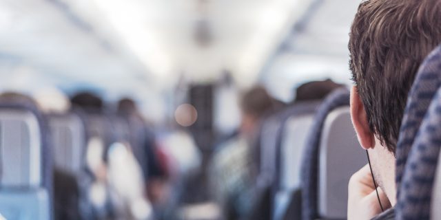 Photo of a man sitting on a plane.