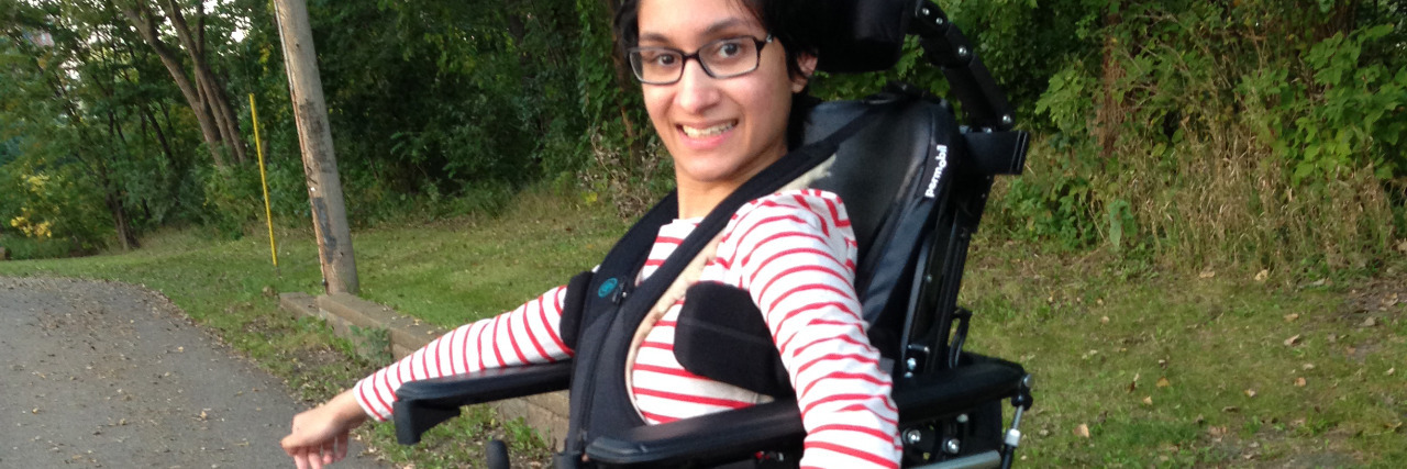 Cerebral Palsy Does Not Define Me. I Define Me. Neha in her standing wheelchair.