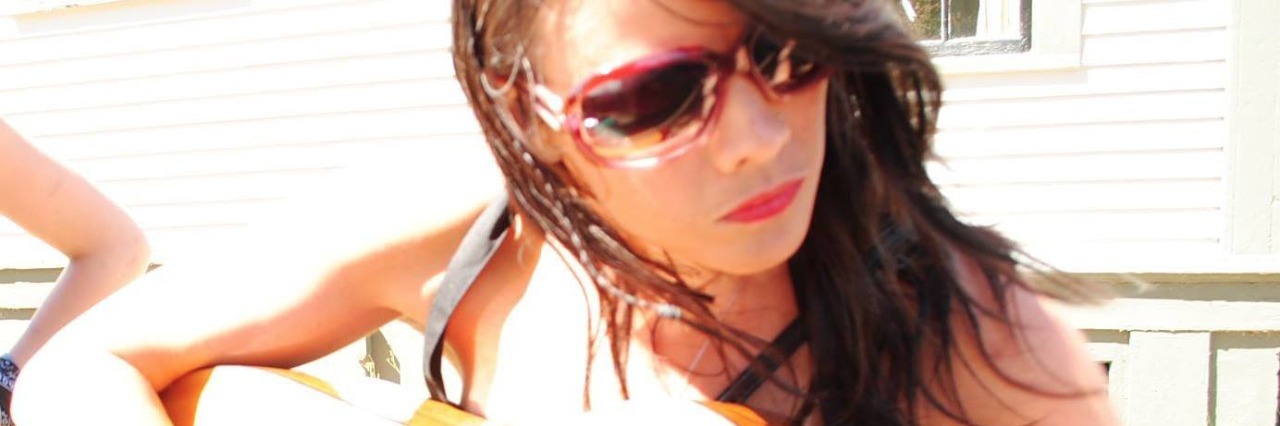 Advice for When Depression Takes Your Creativity woman with sunglasses playing guitar