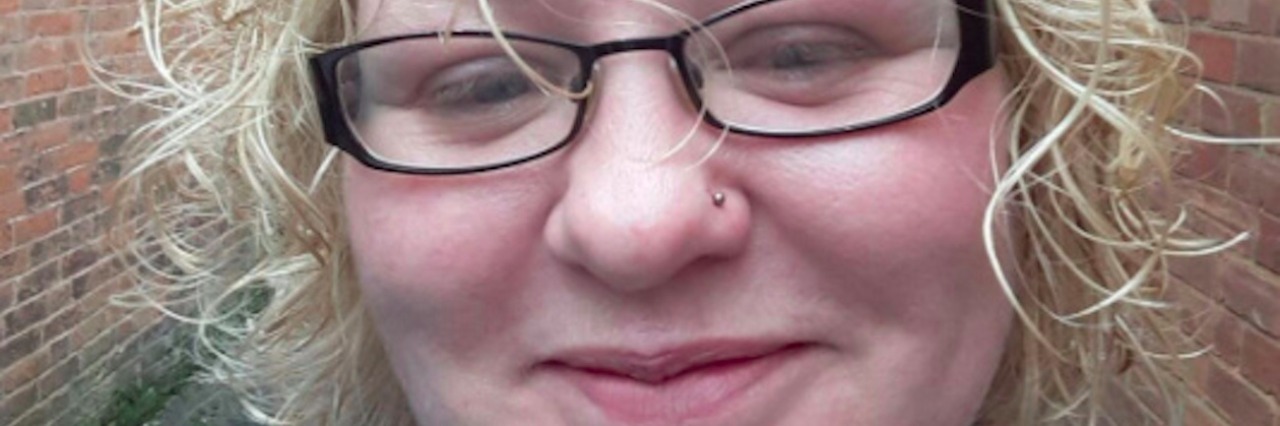 The Roller Coaster of Emotions to Chronic Illness Acceptance Woman with blonde hair, wearing glasses