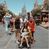 family of five posing at disneyland in front of the castle