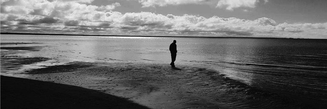 Gifts of Living With Fibromyalgia, Chronic Fatigue Syndrome (CFS) black and white photo of man walking on the beach