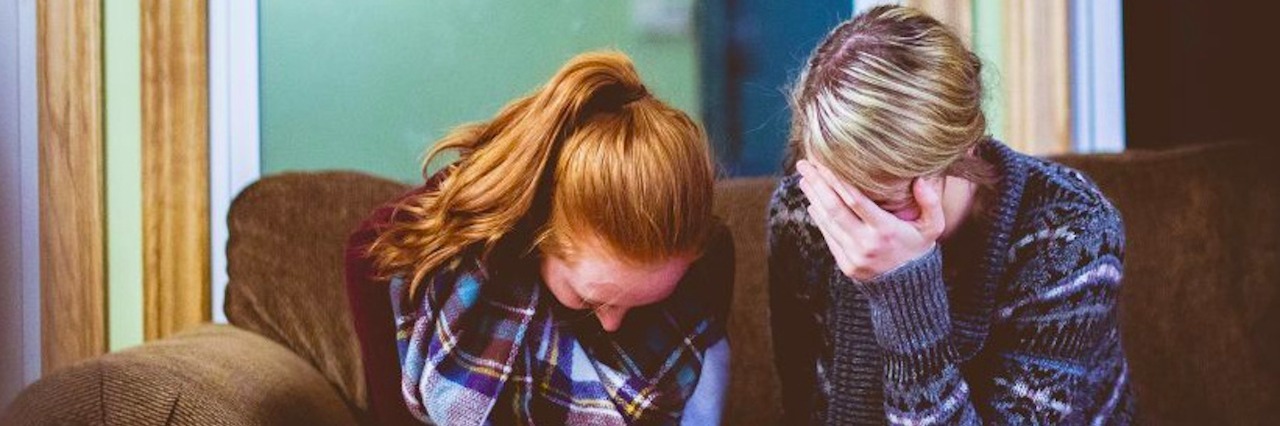 You Deserve to Talk About Your Health Without Feeling Like a Burden two women talking on the couch