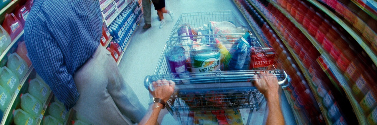 8 Tips to Make It Through the Grocery Store With Ulcerative Colitis fisheye view of aisle in supermarket