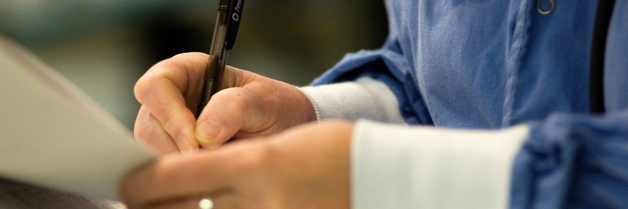 Why Medical Professionals Need to Take Mental Illness Seriously Nurse writing on patient's chart.