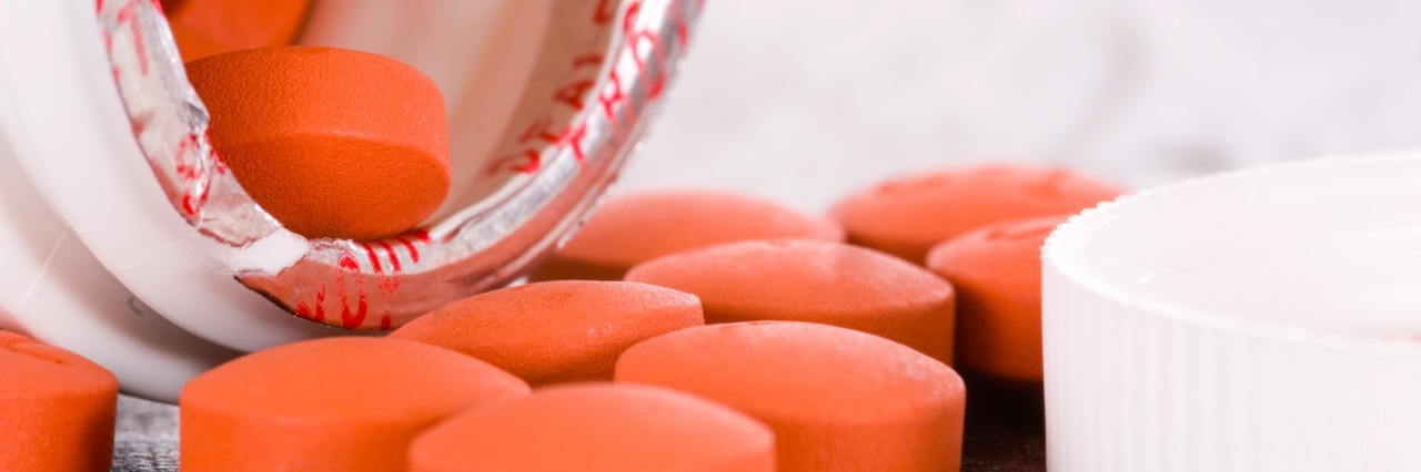 When People Say Ibuprofen Will 'Fix' My Ehlers-Danlos Syndrome orange pills spilling out of pill bottle