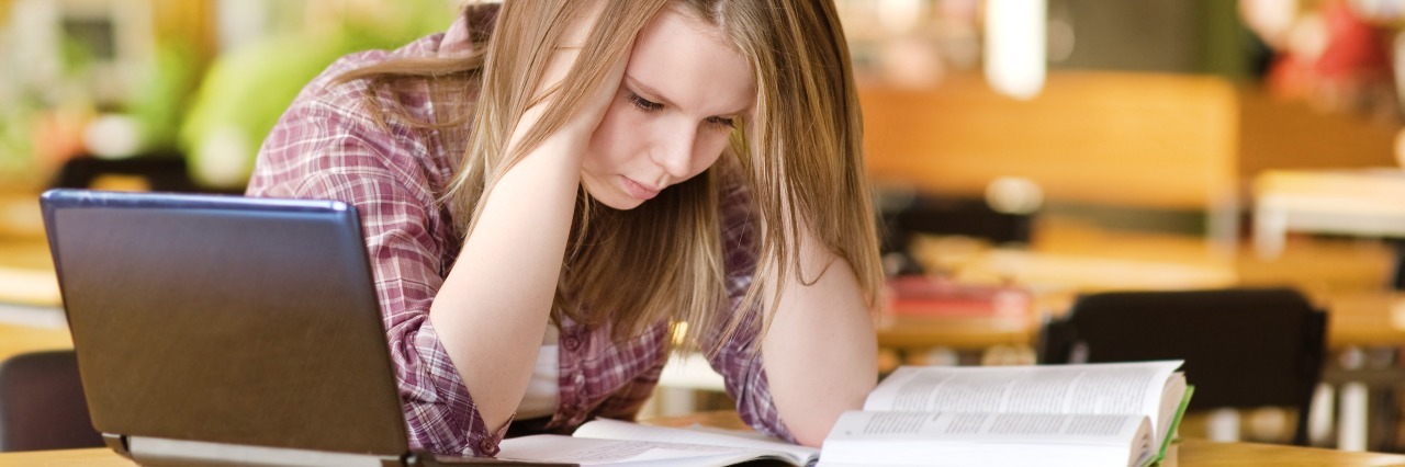 When Being a Prepared Student Is Really Anxiety in Disguise female student with laptop working in library depressed or stressed