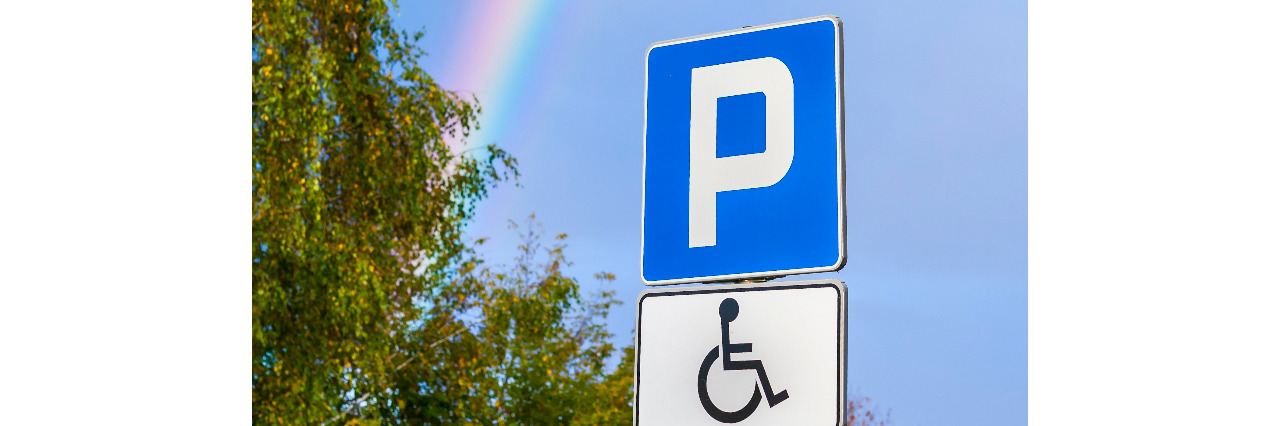 Intersections of Being Queer and Disabled Rainbow over a disability parking space.