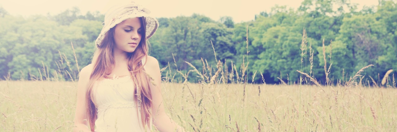 I Am Grateful I Have Inflammatory Bowel Disease Young girl in a hat walking on the field