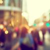 Blurred photo of people walking on city street