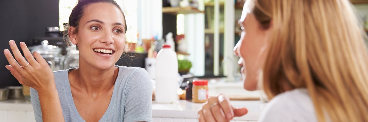 two female roommates talking over breakfast