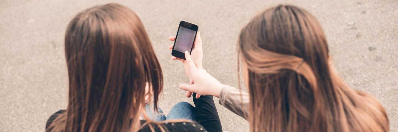 Two young women looking at mobile phone