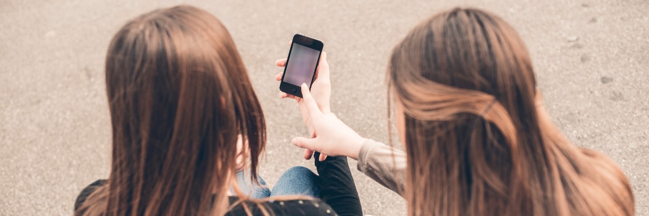 25 Dysautonomia 'Veterans' Give Advice to the Newly Diagnosed Two young women looking at mobile phone