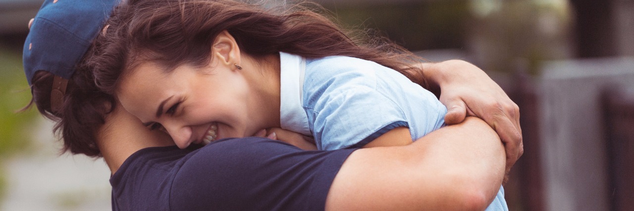 Being in a Relationship When You Have Multiple Sclerosis young couple hugging and laughing