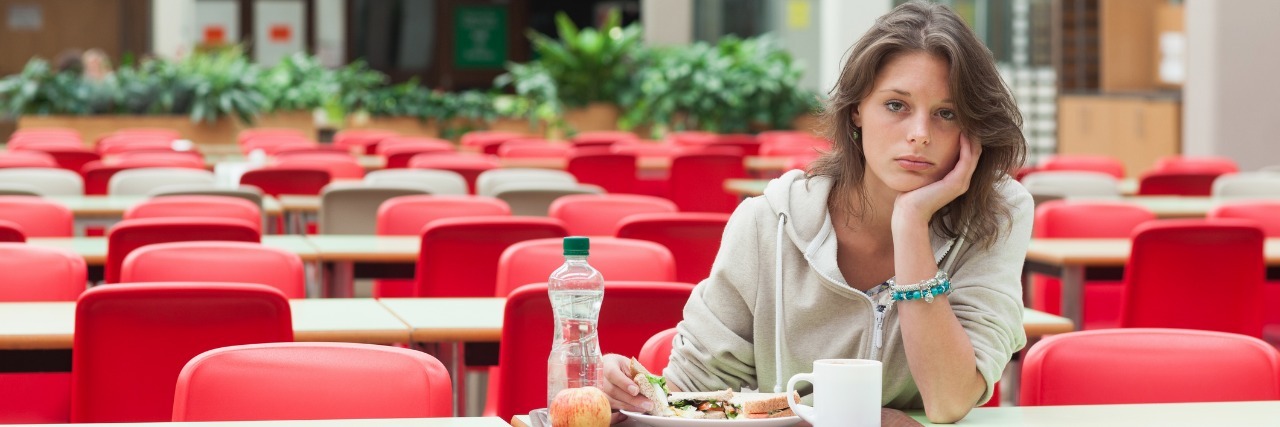 Woman eating lunch alone.