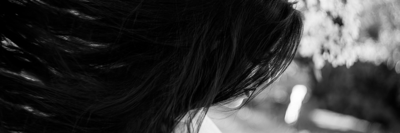 Addressing the Final Taboo: Talking About Mental Illness black and white image woman in garden long hair sadness