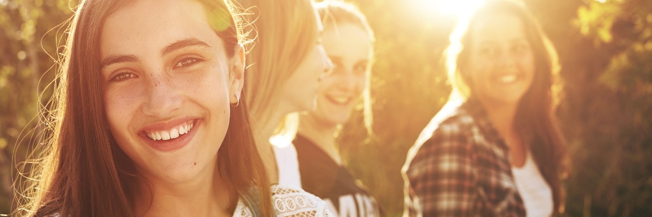 What Teenagers Should Know About Life With Chronic Pain group of teenage girls walking outside and laughing