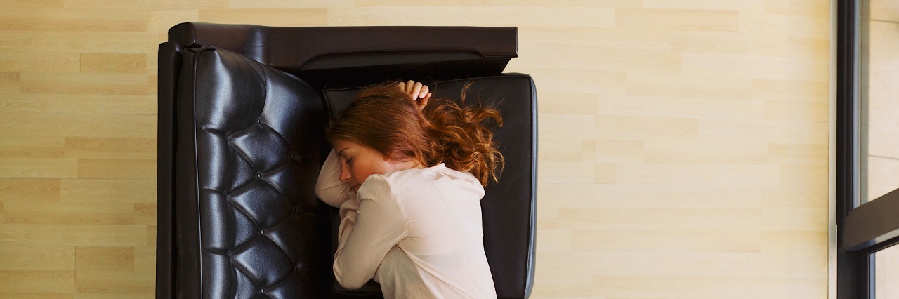 It's OK to Take a 'Couch Day' When You're in Pain Aerial view of young female sleeping on couch