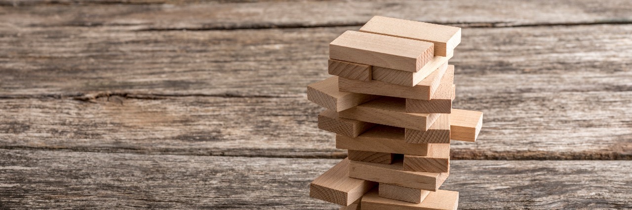 wooden pegs in a tower structure jenga game