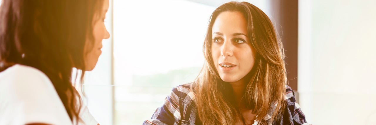 Explaining How I Feel as Someone With CFS/ME Two women sitting at table in cafe with coffee