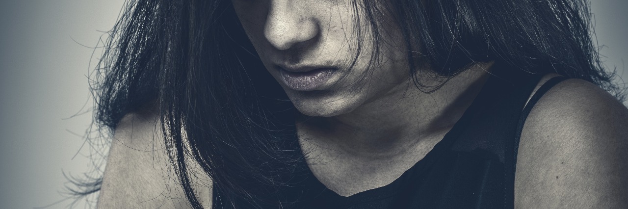 What My Post-Traumatic Stress Disorder (PTSD) Looks Like young woman desaturated image looking sad or afraid