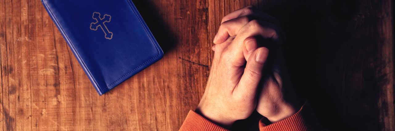 When People Ask How I Keep My Faith When Prayer Doesn't 'Heal' Me Christian woman praying with hands crossed
