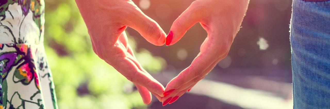 Loving Kindness Metta Meditation for Coping With Lyme Disease Young couple in love holding hands in the sunset in summer evening