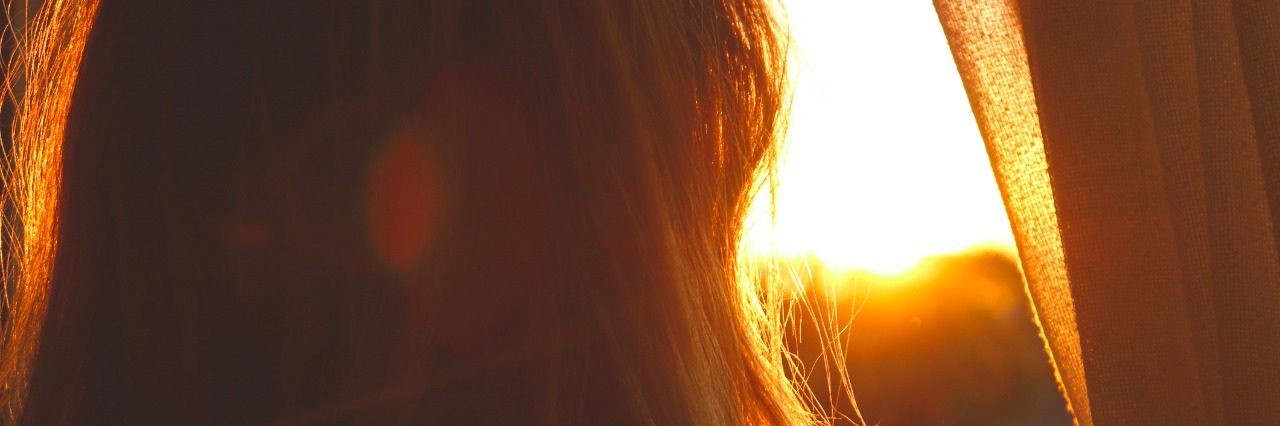 My Doctor's Advice When I Was Tired of Fighting My Illness Woman at sunset looking out window