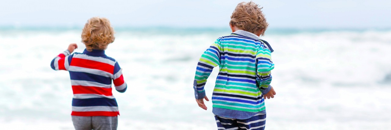 What I Realized About Labels After My Sons' Autism and ADHD Diagnoses Two kid boys playing on beach
