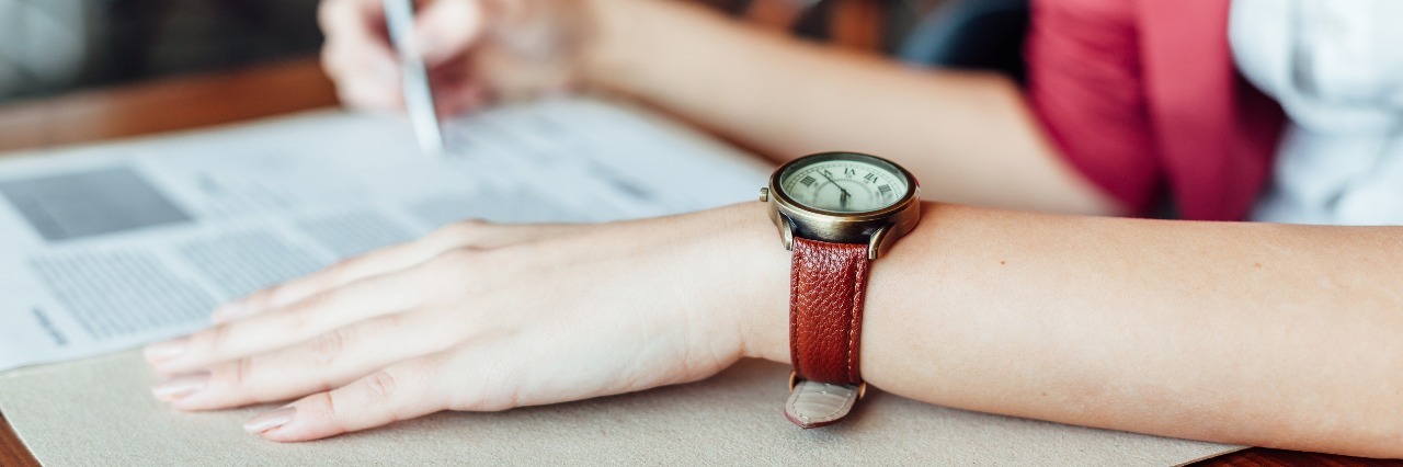 How to Make a Commitment to Depression Recovery woman signing contract wearing leather wristwatch