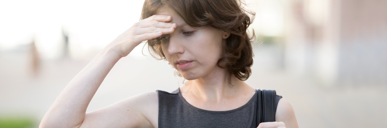 Cognitive Impairment With Fibromyalgia: Effects of Fibro Fog woman walking down the street, frowning, and holding her head in frustration