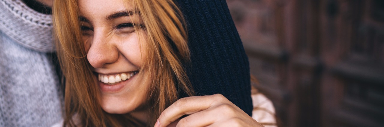 Why I Choose to Laugh About My Illness Teen girl laughing.