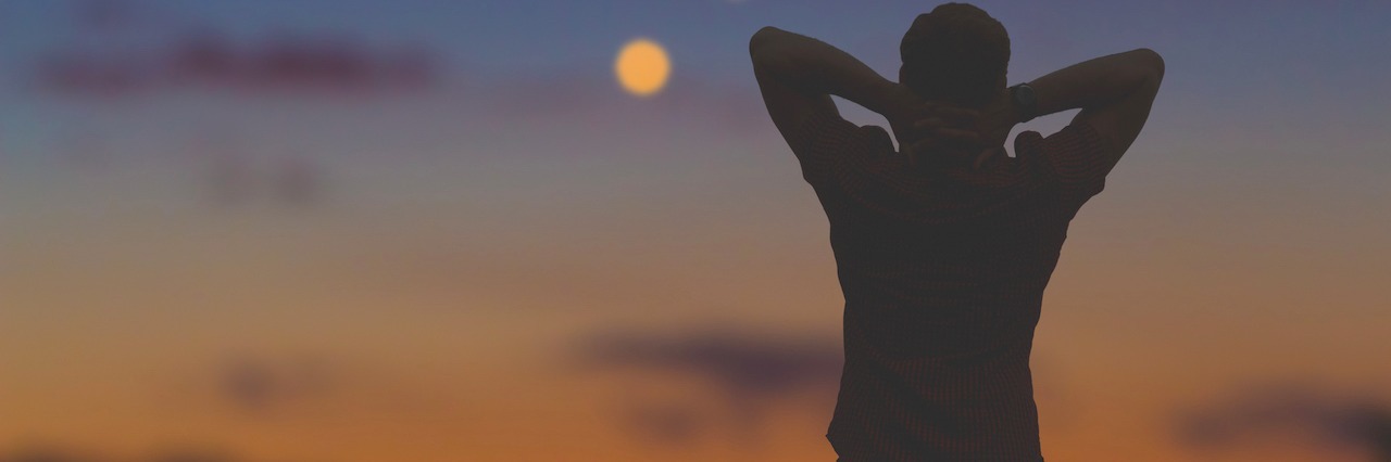 How a Loved One's Suicide Affects Your Mental Health Silouette of a man looking at a city