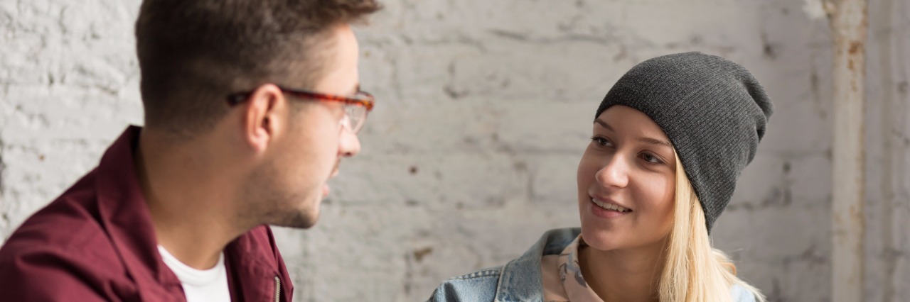 Let's Chat About a Very Taboo Aspect of Chronic Illness A man and woman talk in cafe