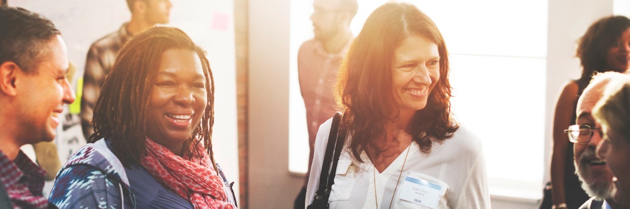 Autism at Work Summit Seeks to Increase Employment Opportunities Coworkers smiling, having a conversation