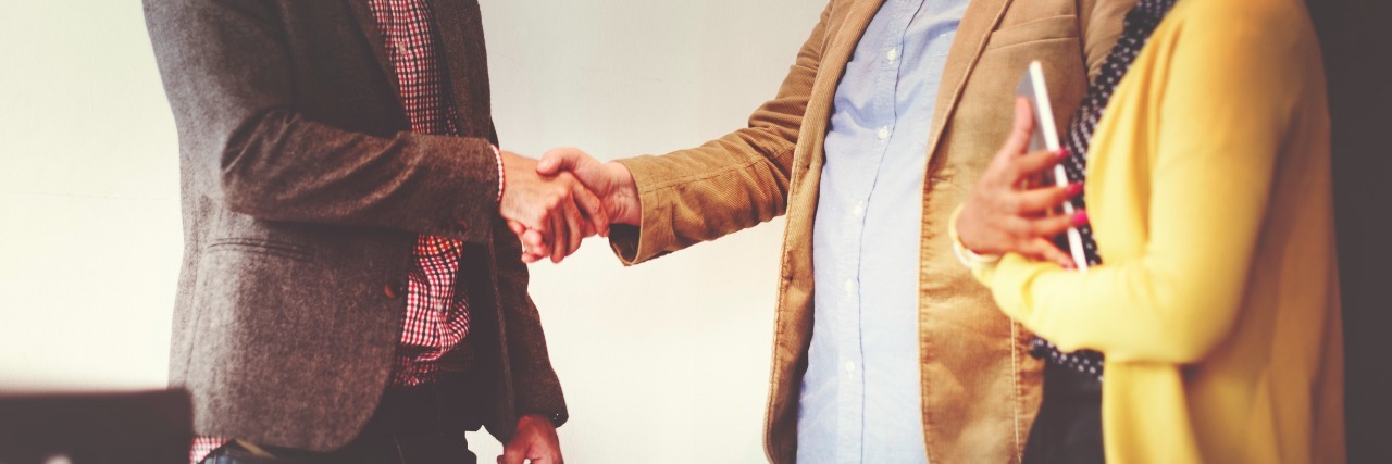 Introducing Myself and Telling People I Have Multiple Sclerosis man shaking hands with another man, woman next to them